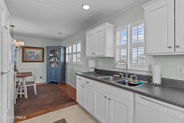 kitchen featuring white cabinets, white appliances, and sink