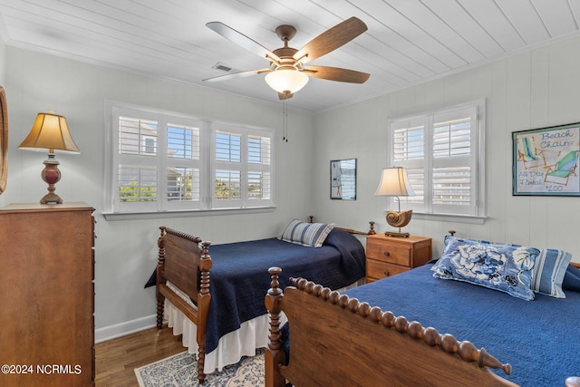 bedroom with hardwood / wood-style flooring, ceiling fan, crown molding, and wood ceiling