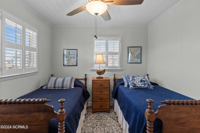 bedroom featuring wooden ceiling, ceiling fan, and crown molding