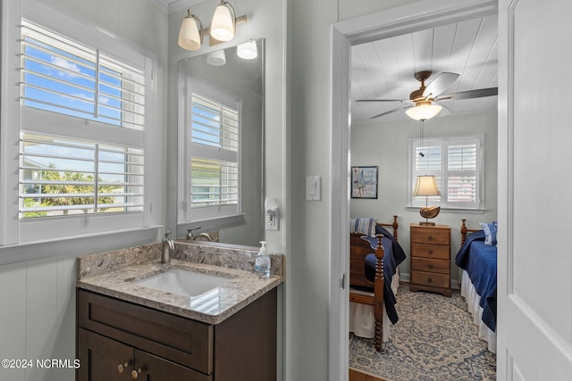 bathroom featuring vanity, a healthy amount of sunlight, and ceiling fan