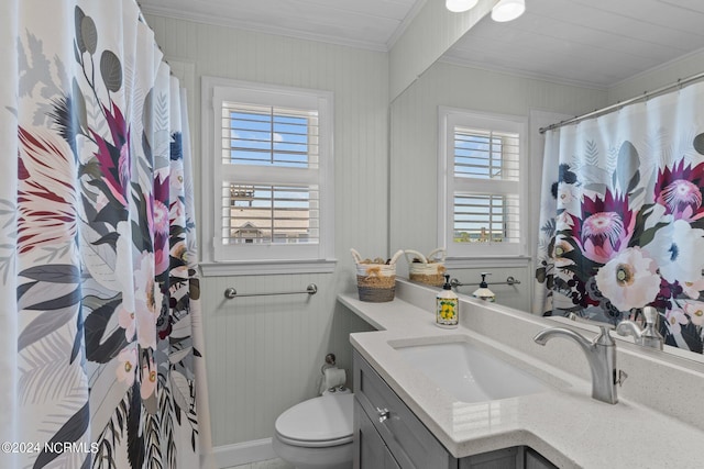 bathroom featuring toilet, vanity, a healthy amount of sunlight, and ornamental molding