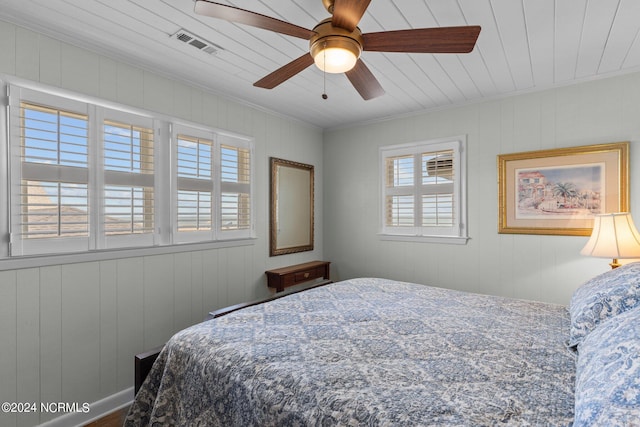 bedroom featuring ceiling fan, ornamental molding, and wooden ceiling