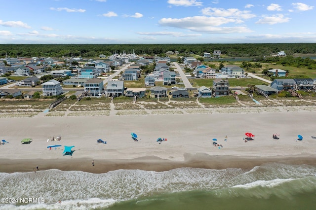 bird's eye view with a water view and a beach view