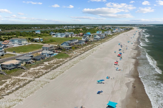 drone / aerial view featuring a beach view and a water view