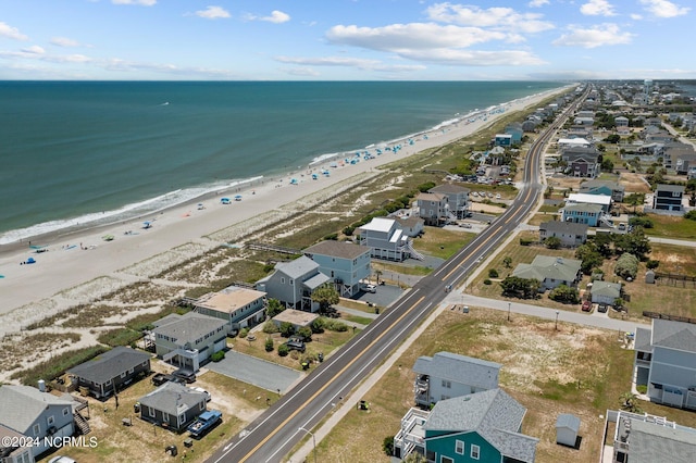 birds eye view of property featuring a view of the beach and a water view