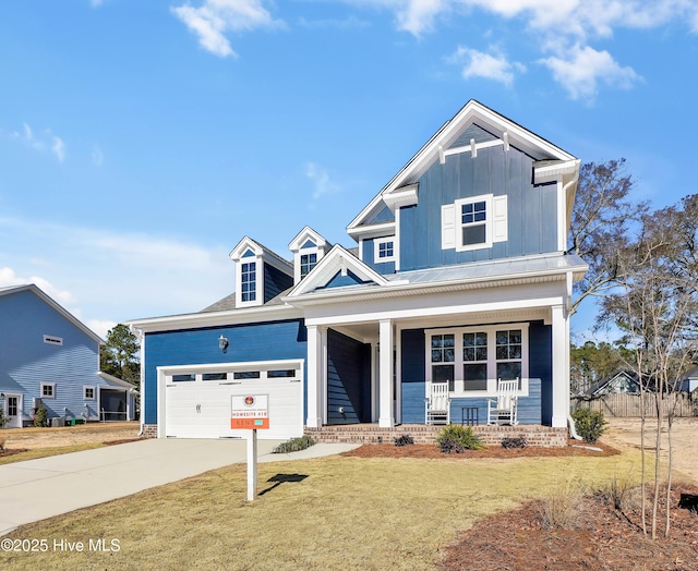 craftsman inspired home with a garage, a front yard, and covered porch