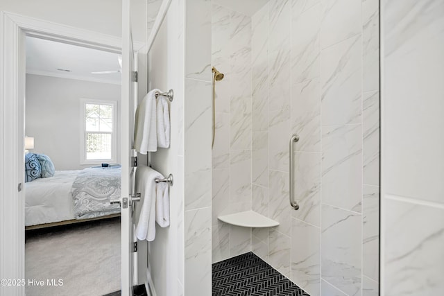 bathroom featuring tiled shower and ornamental molding