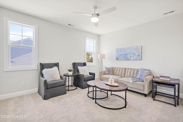 carpeted living room featuring ceiling fan