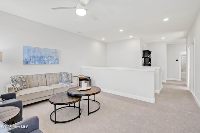 carpeted living room with ceiling fan