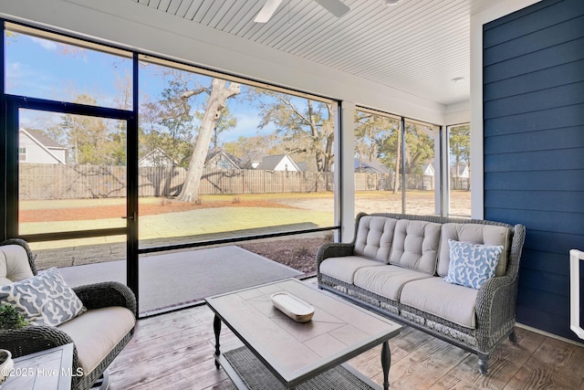 sunroom / solarium featuring ceiling fan