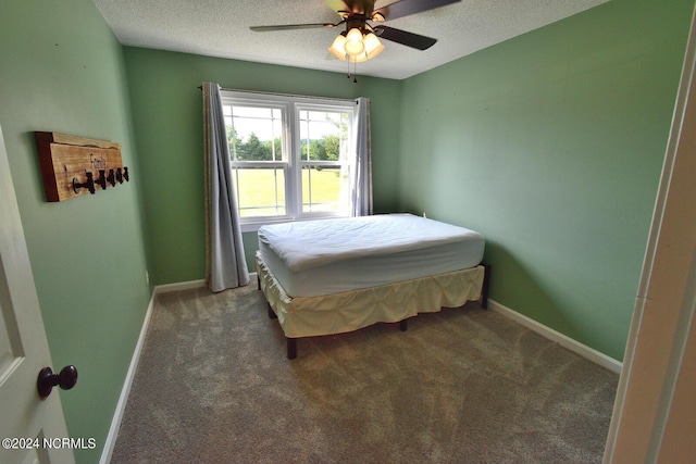 carpeted bedroom with a textured ceiling and ceiling fan