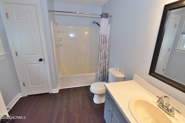 full bathroom with toilet, shower / bath combo with shower curtain, vanity, and hardwood / wood-style flooring