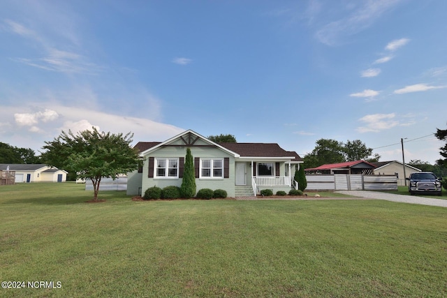 view of front facade with covered porch and a front yard