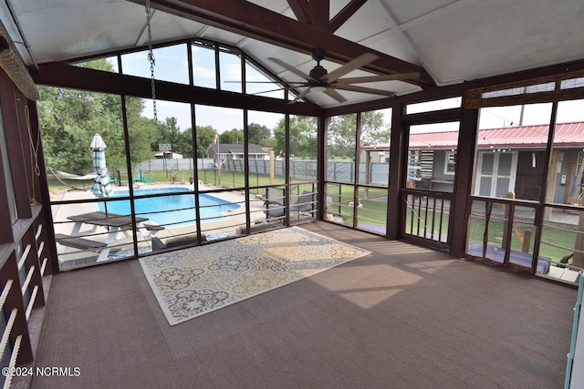 unfurnished sunroom featuring a wealth of natural light, ceiling fan, and lofted ceiling