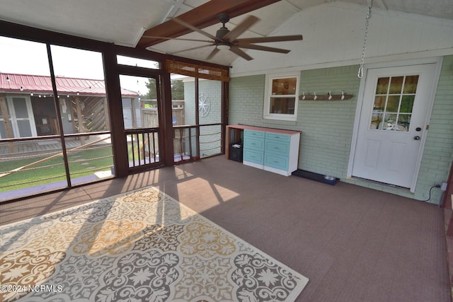 unfurnished sunroom with ceiling fan and lofted ceiling