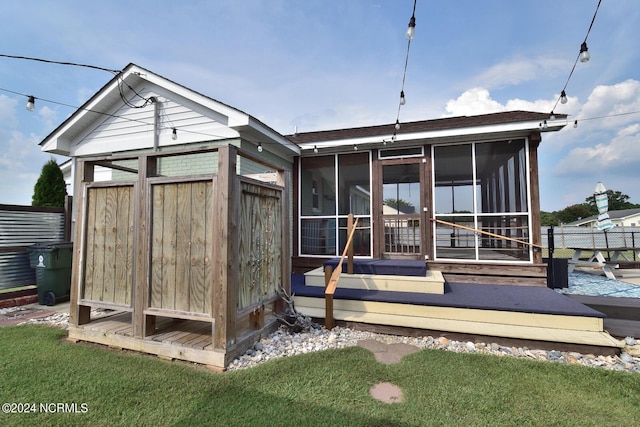 back of property with a sunroom