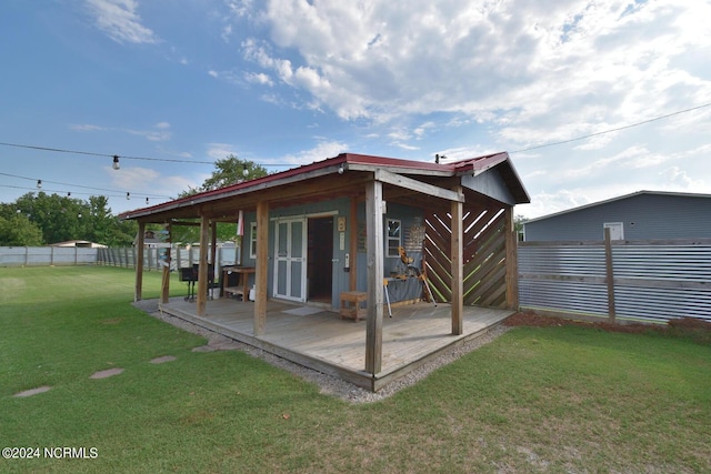 rear view of property featuring a lawn