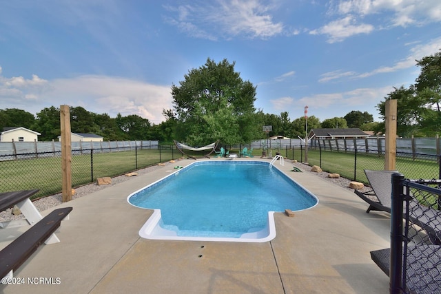 view of pool with a yard