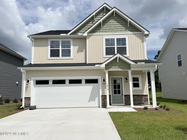 craftsman-style home with a front yard and a garage