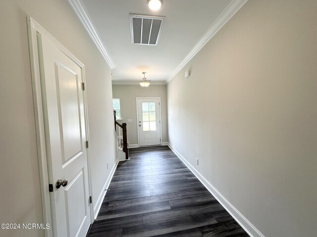 corridor featuring ornamental molding and dark hardwood / wood-style floors