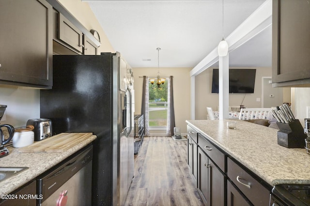 kitchen featuring light hardwood / wood-style floors, appliances with stainless steel finishes, hanging light fixtures, and an inviting chandelier