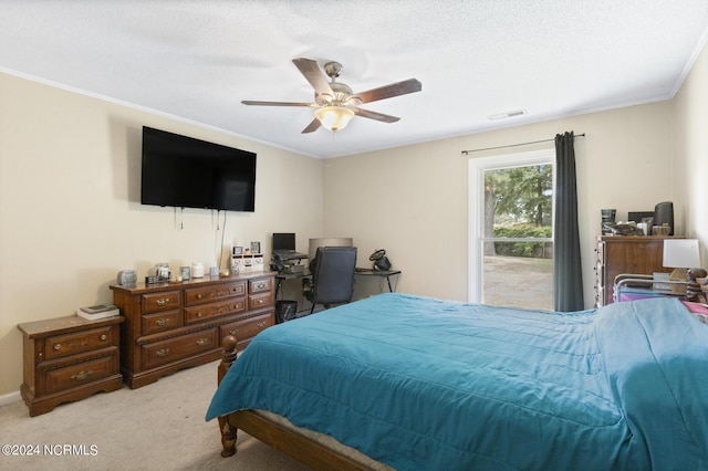 bedroom with light carpet, a textured ceiling, ceiling fan, and ornamental molding