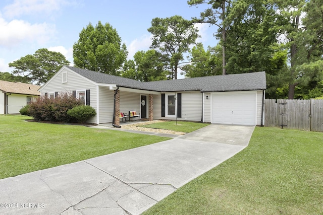 ranch-style house featuring a garage and a front lawn