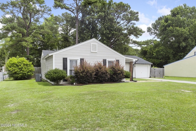 view of front of house with a garage, central air condition unit, and a front yard