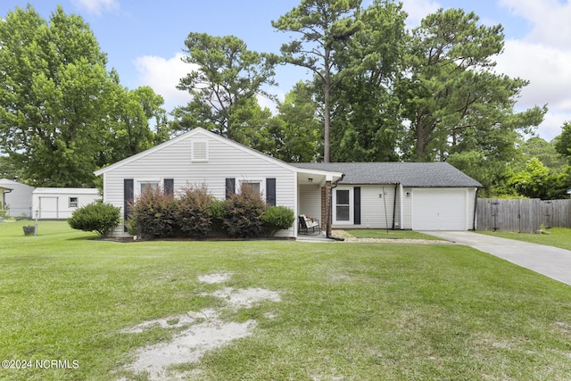 single story home with a garage and a front lawn