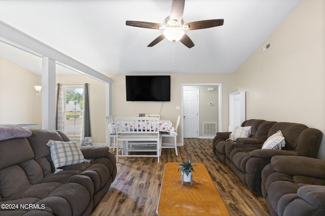 living room with lofted ceiling, ceiling fan, and dark wood-type flooring