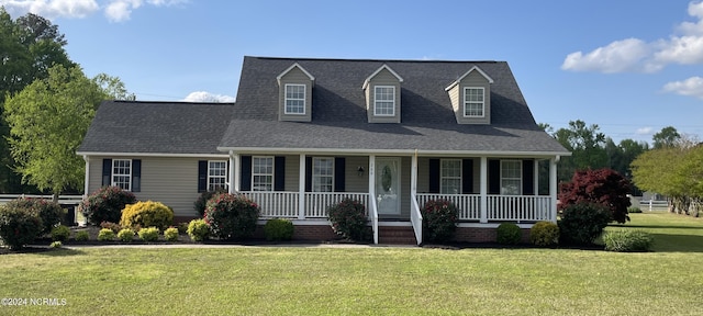 cape cod house with a front lawn and a porch