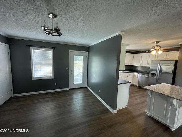 kitchen with appliances with stainless steel finishes, white cabinetry, ornamental molding, and dark wood-type flooring