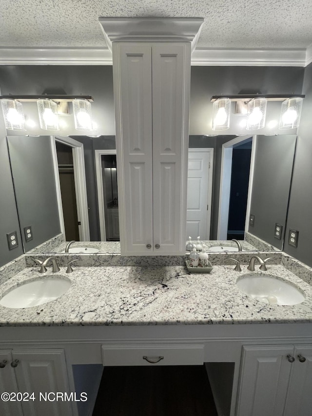 bathroom featuring crown molding and vanity