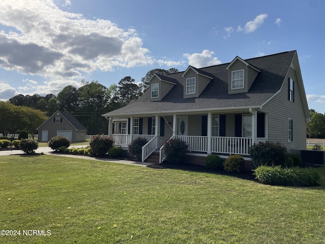 cape cod-style house featuring a garage, covered porch, an outbuilding, and a front yard