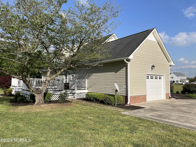 view of side of property with a yard and a wooden deck