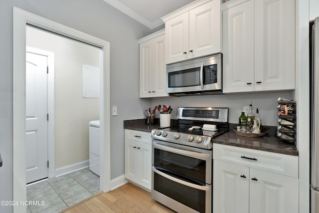 kitchen with white cabinets, appliances with stainless steel finishes, light wood-type flooring, and crown molding