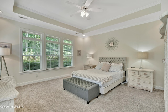 bedroom with light colored carpet, a raised ceiling, ceiling fan, and ornamental molding