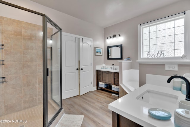 bathroom featuring separate shower and tub, hardwood / wood-style floors, and vanity