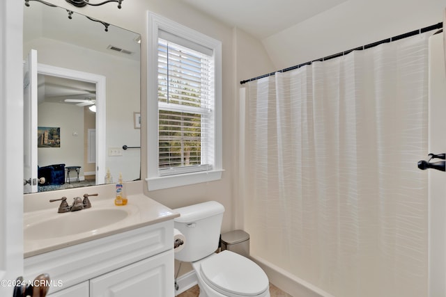 bathroom with a shower with shower curtain, vanity, toilet, and ceiling fan