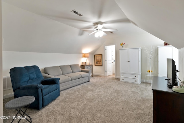 carpeted living room with ceiling fan and lofted ceiling