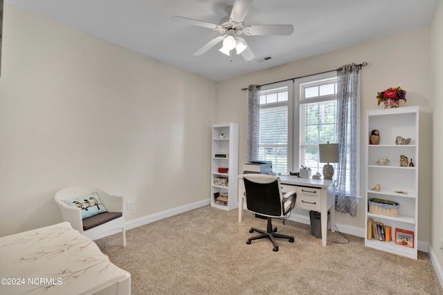 home office with light carpet and ceiling fan