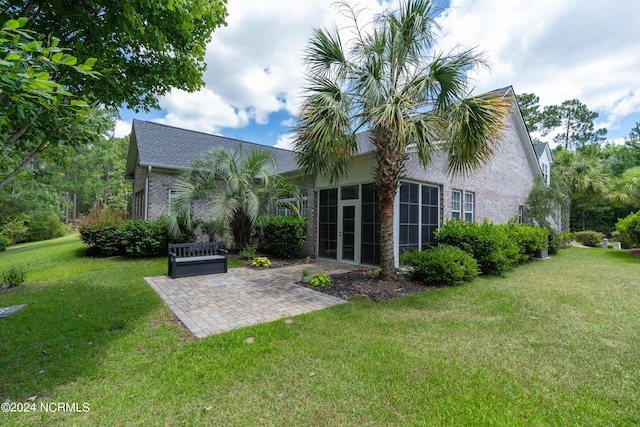 back of property featuring a yard and a patio area