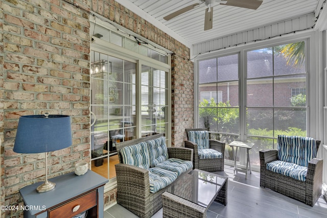 sunroom / solarium featuring plenty of natural light and ceiling fan