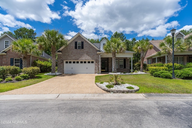 view of front of property with a front yard and a garage