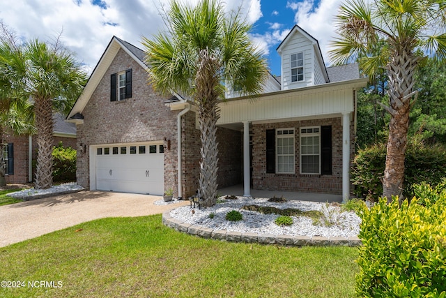 view of front of property with covered porch, a garage, and a front lawn