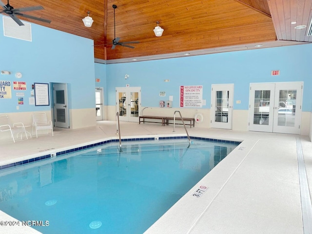 view of swimming pool with ceiling fan and french doors