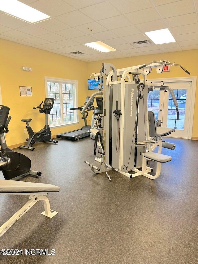 exercise room featuring a drop ceiling