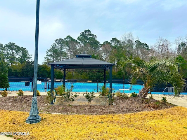 view of swimming pool with a gazebo and tennis court