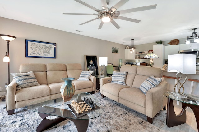 living room featuring light hardwood / wood-style flooring and ceiling fan