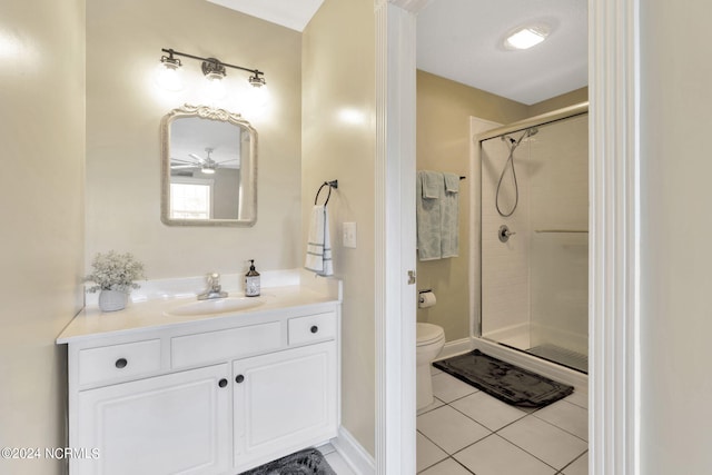 bathroom with vanity, a shower with shower door, toilet, and tile patterned flooring